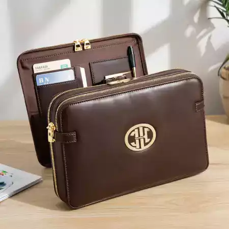 Close-up of a ManBagCo leather bag with custom embossed initials, highlighting personalization options