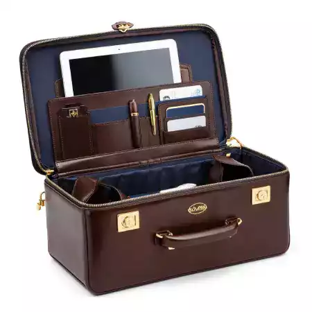 Leather luggage tag with embossed initials attached to a ManBagCo bag handle