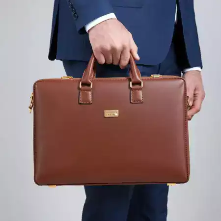Sleek ManBagCo leather briefcase on a modern office desk